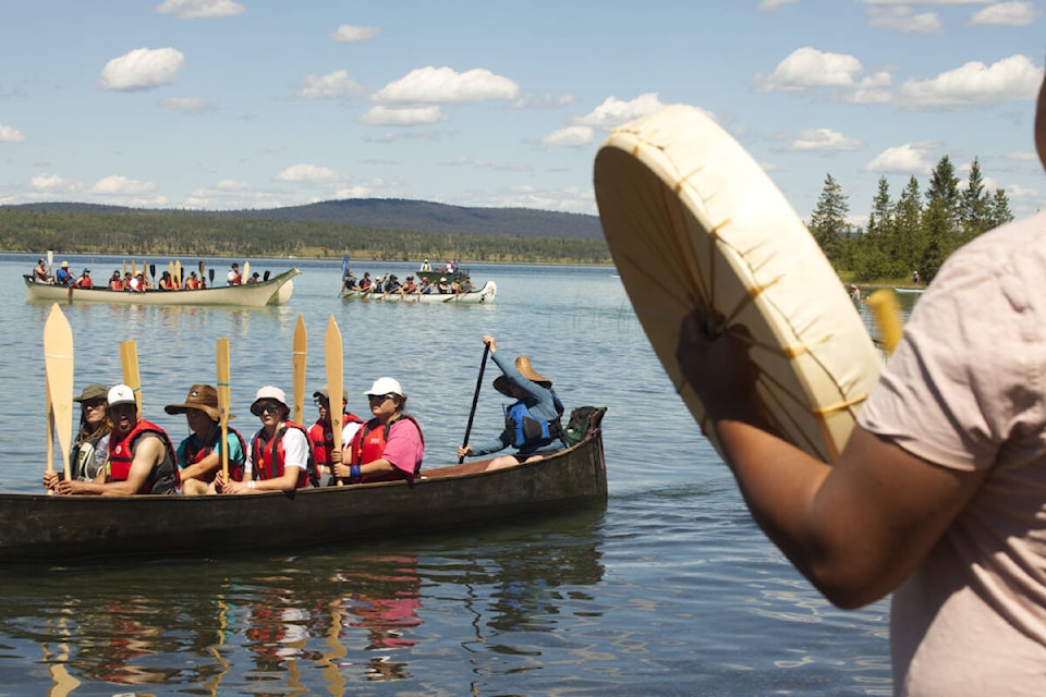 Carl Archie drums on the shores of Green Lake to welcome participants in the Pulling Together Canoe journey last Wednesday, Aug. 20. Green Lake is very special to the Secwepemc people, (Kelly Sinoski photo - 100 Mile Free Press).