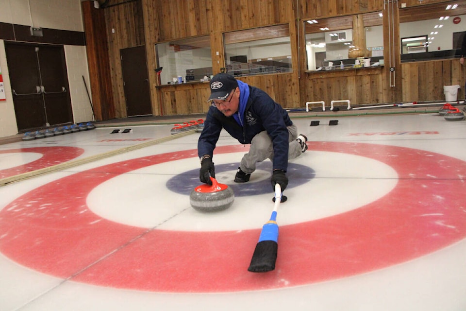 Richard Minato shows how it’s done during a learn-to-curl lesson. (Patrick Davies photo - 100 Mile Free Press)