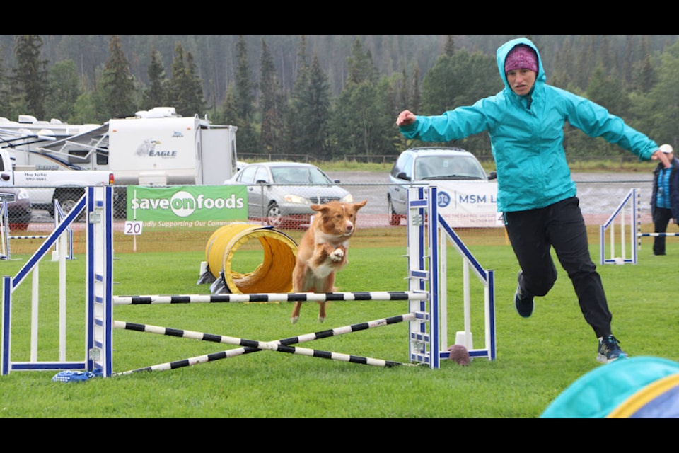 Amy Jordan congratulates her dog Selkie after a successful agility run last Saturday. (Patrick Davies photo - 100 Mile Free Press)