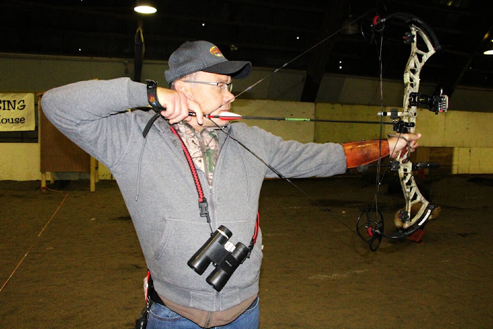 Fred Streleoff uses his compound bow during the Bighorn Archery Club’s annual Indoor 3-D Shoot. (Patrick Davies photo - 100 Mile Free Press)