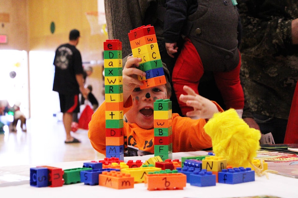 Roland Bouwknecht tests how high he can build two towers of blocks at the Three-Year-Old Roun-Up last Saturday. (Patrick Davies photo - 100 Mile Free Press)