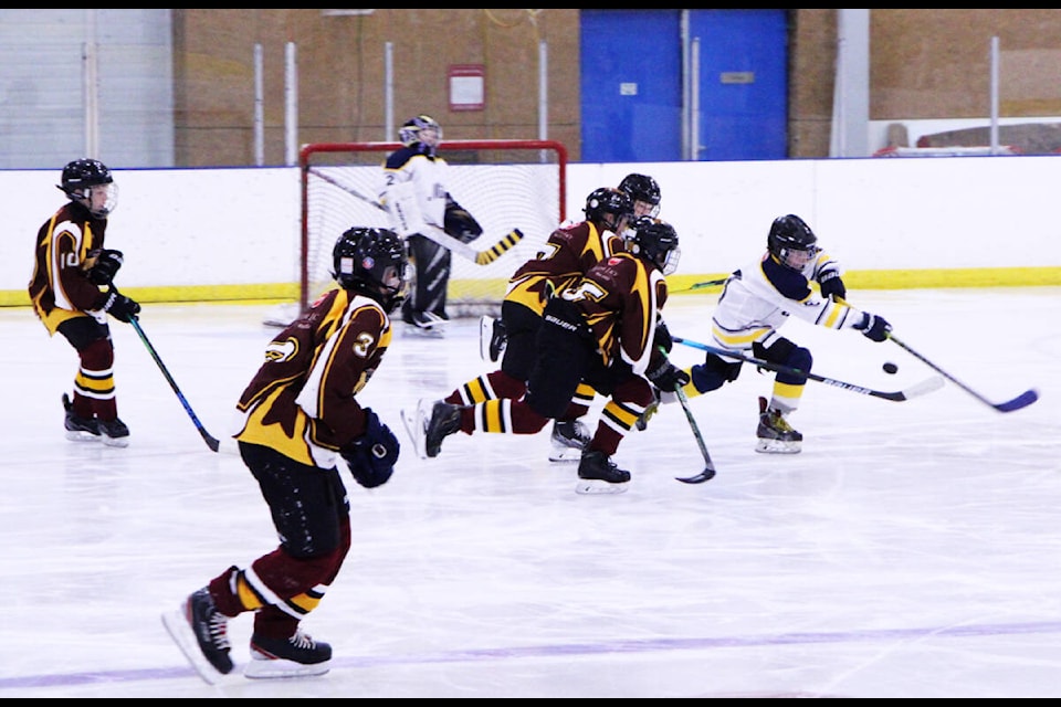 100 Mile Millers’ player Shia Briggs keeps the puck away from the Quesnel Thunder during 100 Mile’s U13 Icebreaker Tournament. (Patrick Davies photo - 100 Mile Free Press)