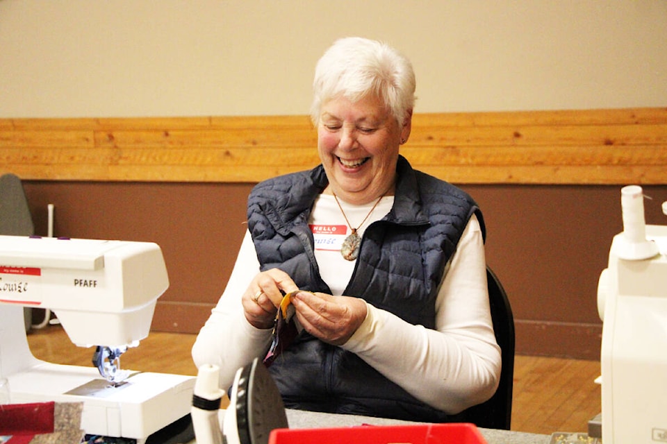 Louise Traill smiles as she creates a pattern for her quilt at a quilt workshop sponsored by Dancing Quilts. (Patrick Davies photo - 100 Mile Free Press)
