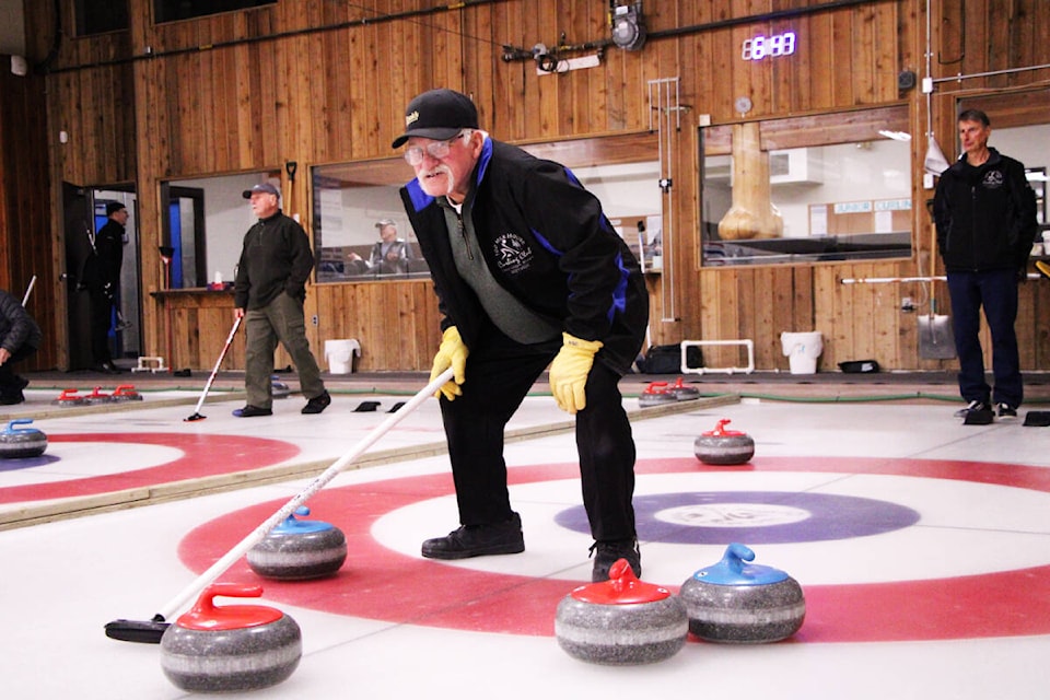 100 Mile Curling Club member Doug Meier marks out the play for his team during a curling game last week. (Patrick Davies photo - 100 Mile Free Press)