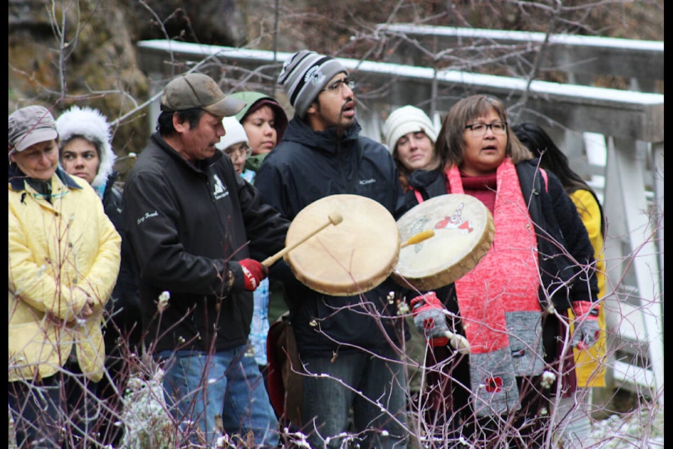Terry Frank (left) and Joseph Archie played drums while Margo Archie followed along with a handmade rattle. (Fiona Grisswell photo - 100 Mile Free Press)