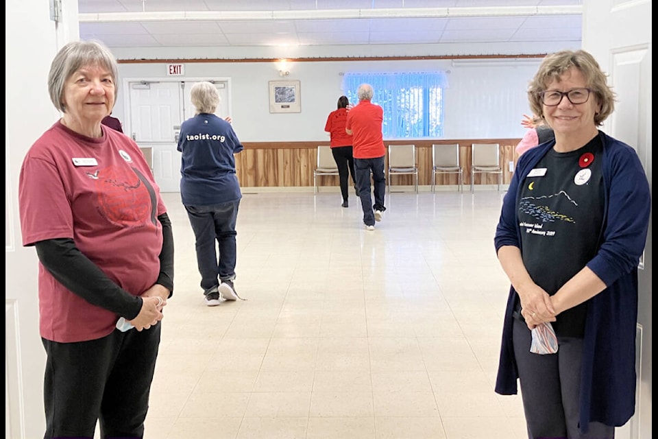Jane Duncan (L) and Karen Broughton stand in front of their Tai Chi class at the Creekside Seniors Center. (Fiona Grisswell photo - 100 Mile Free Press)