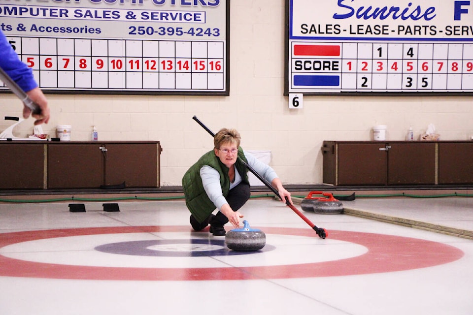 Trudy Folk throws a curling rock during a mixed bonspiel last Saturday. (Patrick Davies photo - 100 Mile Free Press)