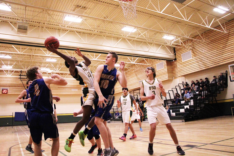 The PSO Eagles and Barriere Cougars clash below the Cougars’ net in 100 Mile House last week. (Patrick Davies photo - 100 Mile Free Press)