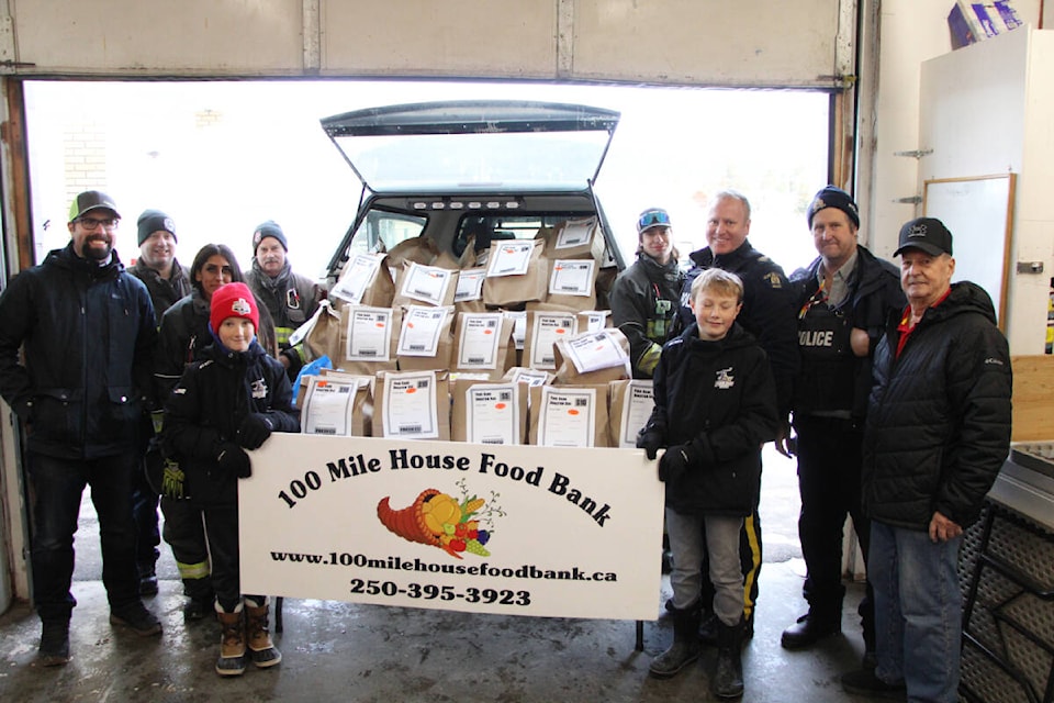 Members of 100 Mile Fire Rescue, 100 Mile Minor Hockey Association’s U13 Team and FreshCo joined the 100 Mile House RCMP in running their annual Cram the Cruiser fundraiser. FreshCo store manager Daniel Broddy said they raised $3,000 for the 100 Mile House Food Bank Society. (Patrick Davies photo - 100 Mile Free Press)