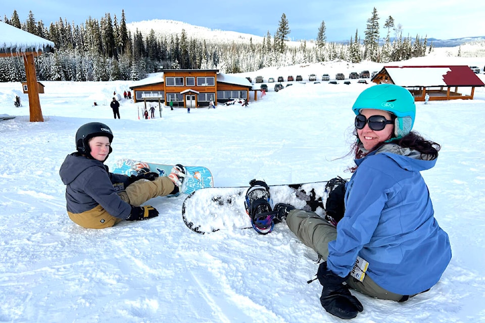 Parker and Martina Page take a break from snowboarding at the top of the bunny hill on New Year’s Day. (Angie Mindus photo - Williams Lake Tribune)