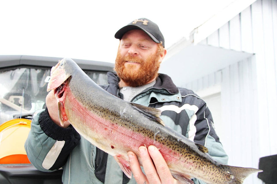100 Mile House’s Rob Tait won the seventh annual Highway 24 Ice Fishing Derby after landing a 5.75-lb rainbow trout. See story on A12. (Patrick Davies photo - 100 Mile Free Press)