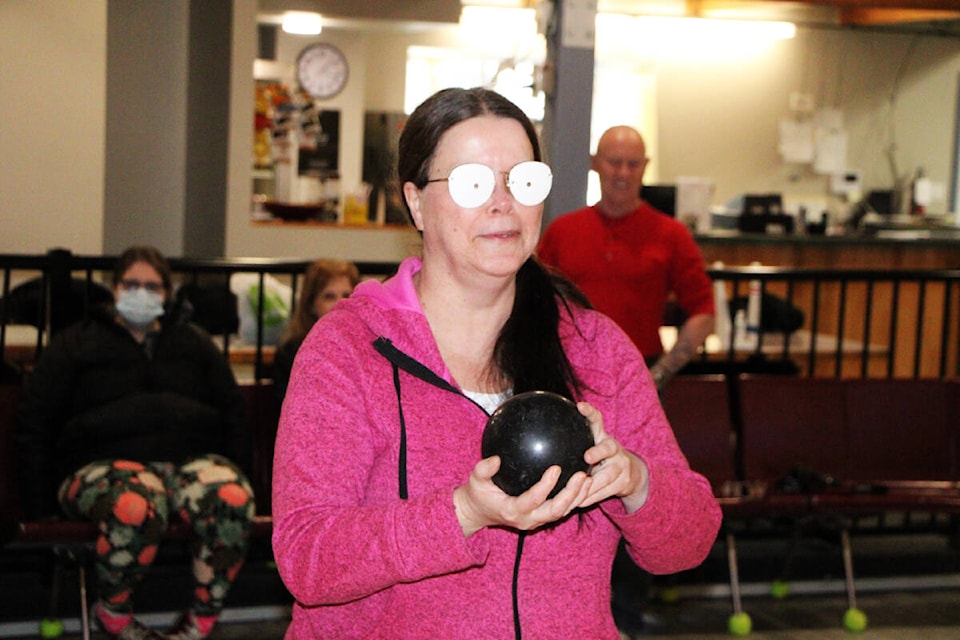 Fiona Grisswell tries bowling while wearing a pair of glasses that simulate retinitis pigmentosa. (Patrick Davies photo - 100 Mile Free Press)