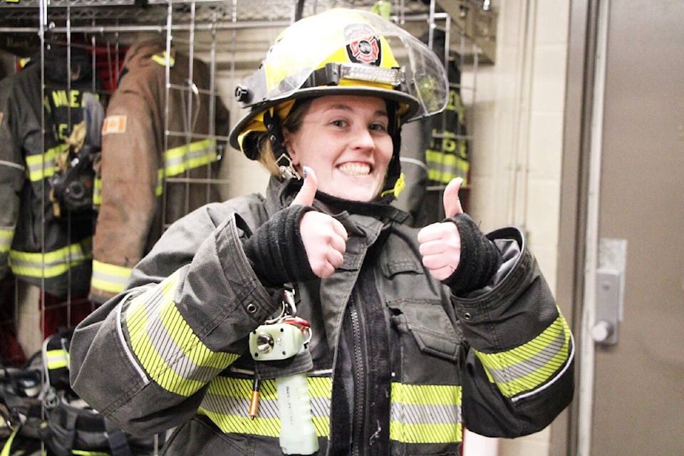Delaney Speers flashes a thumbs up after successfully putting on her firefighting gear in under a minute. (Patrick Davies photo - 100 Mile Free Press)