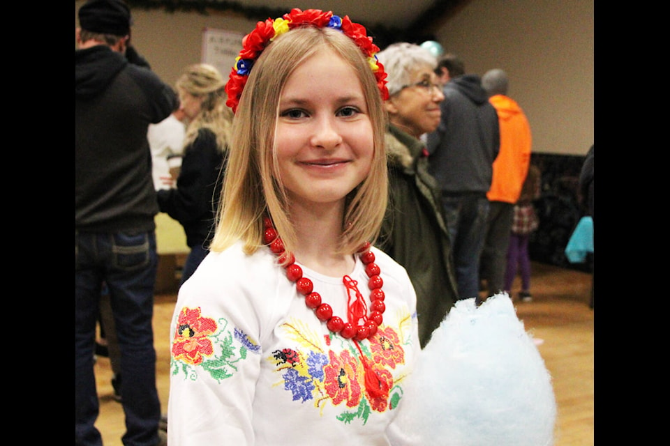 Diana Kozakov enjoys some cotton candy at the 100 Mile Community Hall. (Patrick Davies photo - 100 Mile Free Press)