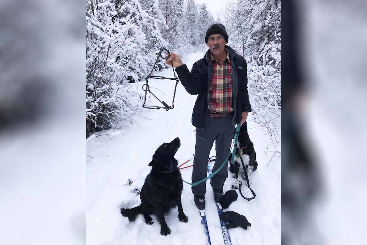 Martin Brilling is pictured holding up the conibear hunting trap that his dog Jackson (left) was caught in in 2020. Brilling is warning residents to keep their dogs leashed up and to know how to open the traps after his dog nearly died. (Submitted photo)