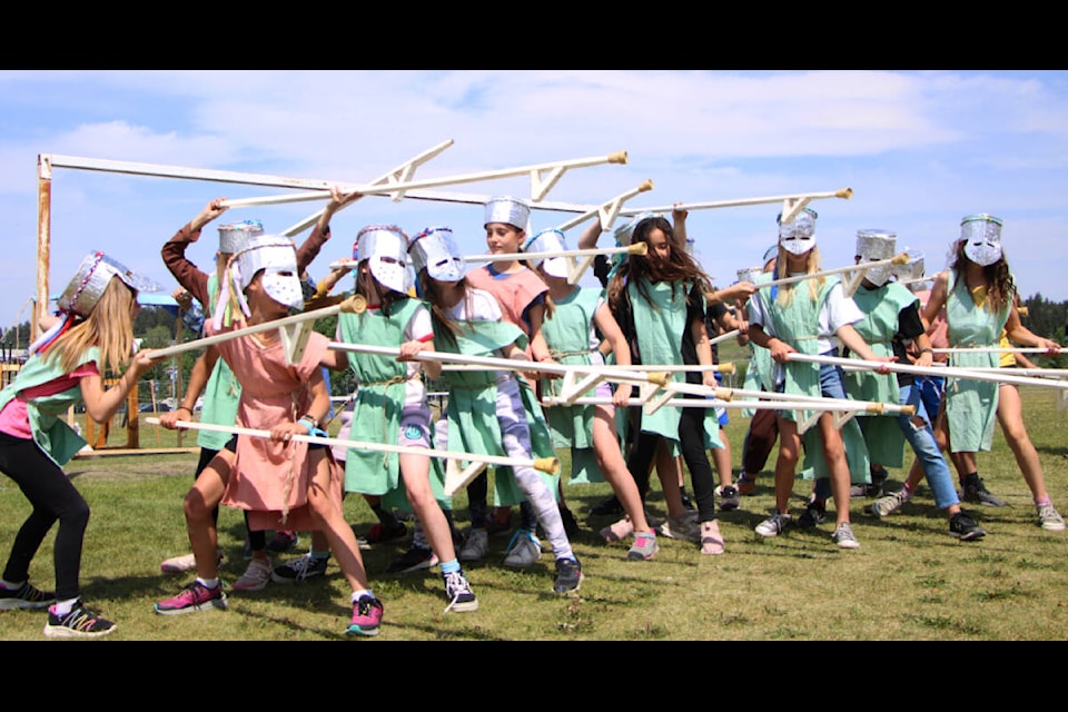Members of Tristan Feissli’s Grade 4-6 class show off their pikeman skills while wearing homemade tabards and helmets at 100 Mile Elementary’s Medieval Fair on Friday, June 9. (Patrick Davies photo - simplymastery) Members of Tristan Feissli’s Grade 4-6 class show off their pikeman skills while wearing homemade tabards and helmets at 100 Mile Elementary’s Medieval Fair on Friday, June 9. (Patrick Davies photo - simplymastery)