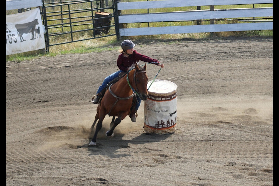 Denver Lytton of 100 Mile House brushes the edge of the barrel in the senior girls barrel race at the Little Britches rodeo on Sunday, Aug. 20. (Fiona Grisswell photo - simplymastery)
