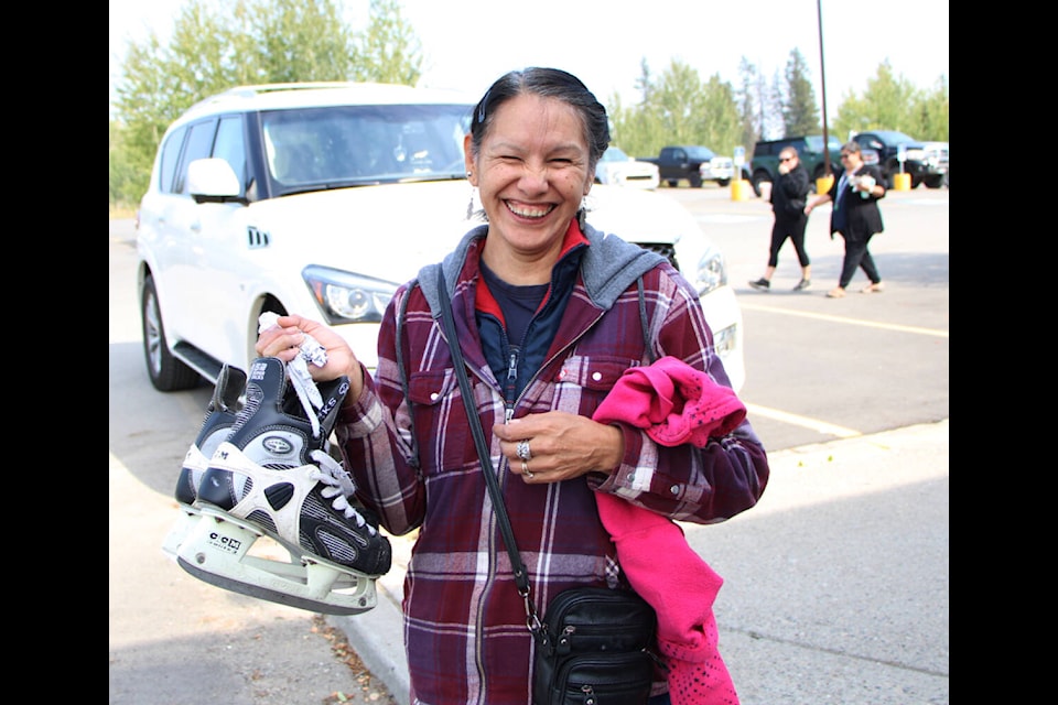 Karen Pellerin shows off the new skates she acquired at 100 Mile Minor Hockey’s equipment swap at the South Cariboo Rec Centre. (Patrick Davies photo - 100 Mile Free Press)