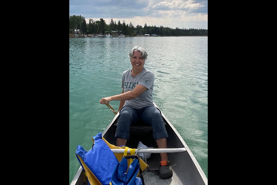 Sandy Labinsky floating on a boat in Green Lake.