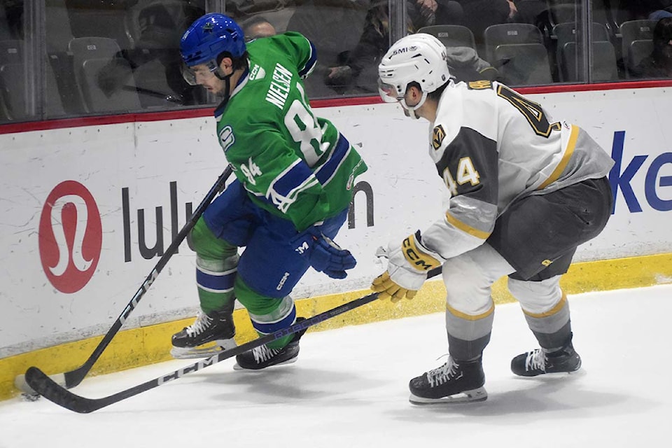 Layton Ahac tries to check Abbotsford's Tristen Nielsen during AHL regular season action last year. 