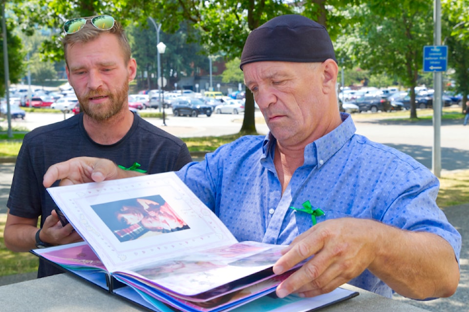 Ray (left) and Jeremiah Gauthier look through an album of pictures of their daughter/sister Chelsey outside the Abbotsford Law Courts on Tuesday (July 22) after the conviction of her killer.