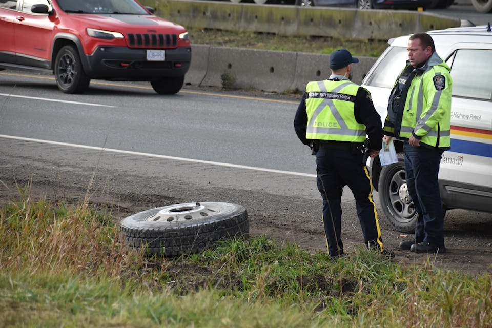 Two wheels came loose from a dump truck Thursday morning (Nov. 28) on Highway 1 in Abbotsford, and one of them struck another vehicle. 
