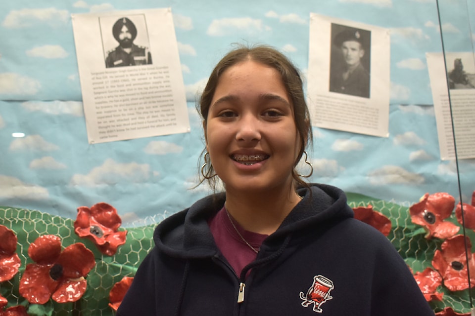 Ava Gill, with her great-grandfather's photo and write-up over her right shoulder, learned a new piece to her family's puzzle due to a Remembrance Day assignment.
