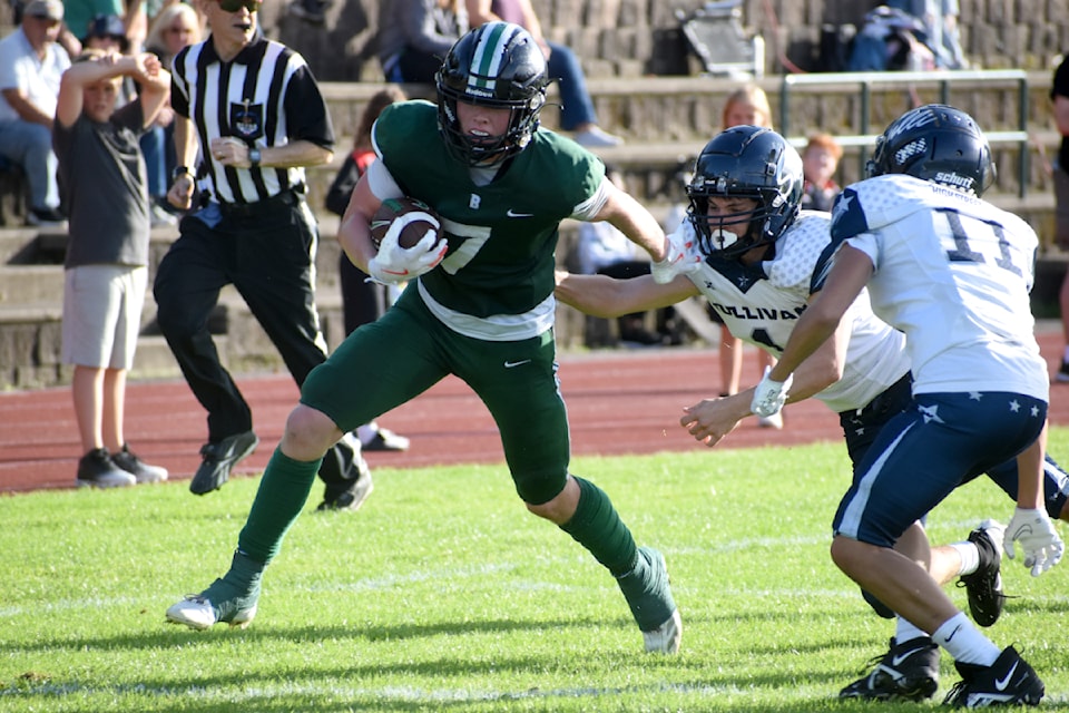 Cade Handy darts around Sullivan Heights defenders. 