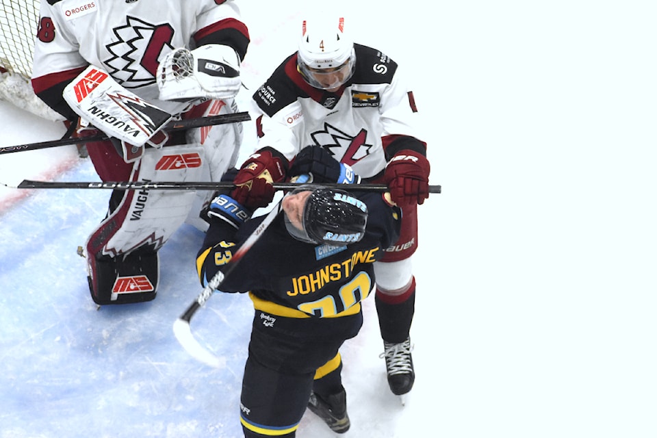 Chilliwack's Price Grimes clears out a Spruce Grove player from the front of the net. 