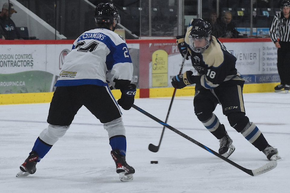 91ԭ's Ronan Coopman tries to deke around an Abbotsford defender.