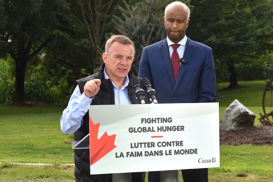 Canadian Foodgrains Bank executive director Andy Harrington speaks with  Minister of International Development Ahmad Hussen looking on. 