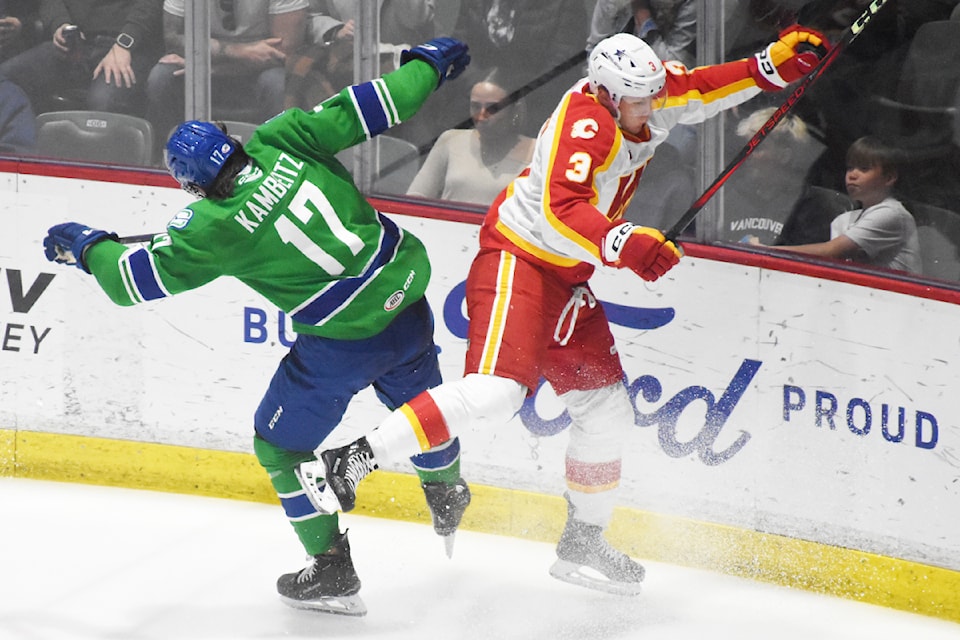 Abbotsford's Dino Kambeitz collides with Calgary's Artem Grushnikov on Saturday (April 12).