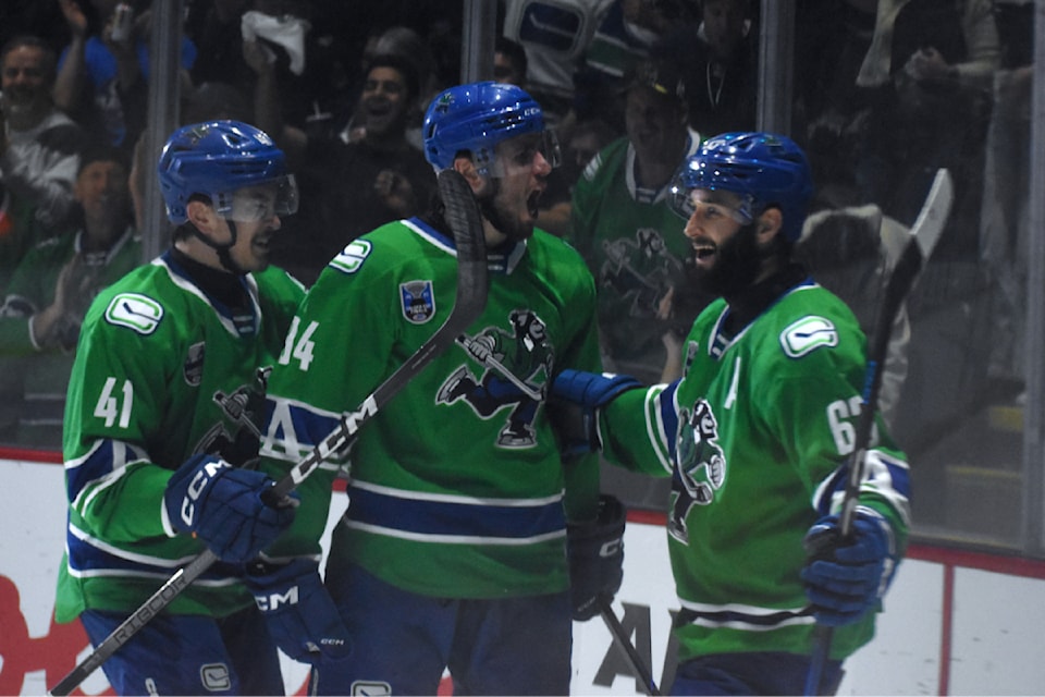 Linus Karlsson (middle) celebrates a goal with Max Sasson (right) and Akito Hirose (left). 