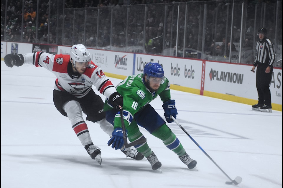 Abbotsford's Danila Klimovich drives to the net against Charlotte's Mikulas Hovorka. 