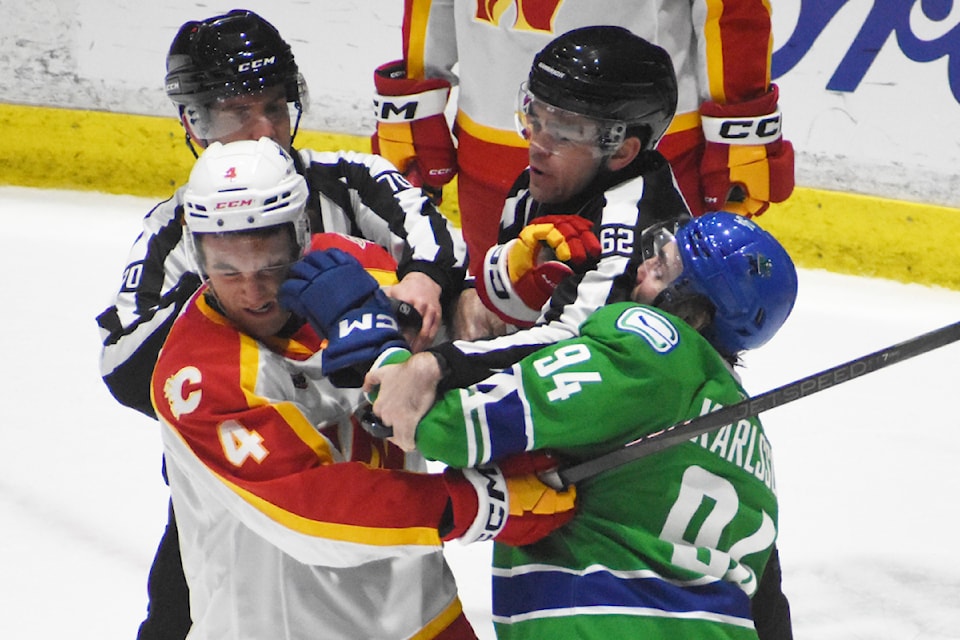 Abbotsford's Linus Karlsson tussles with Calgary's Jeremie Poirier in the second period. 