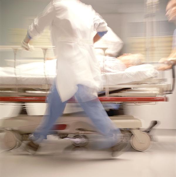 Doctors pushing patient on trolley (blurred motion)