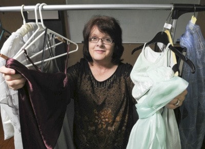 Linda Anderson with some of the dresses she has collected.