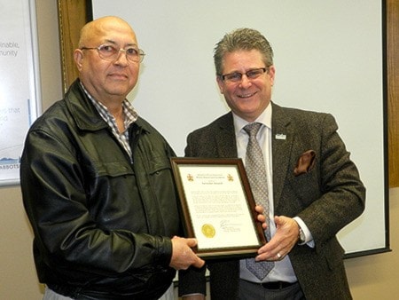 Kanwalbir Dosanjh receives his award of commendation from Mayor Bruce Banman.