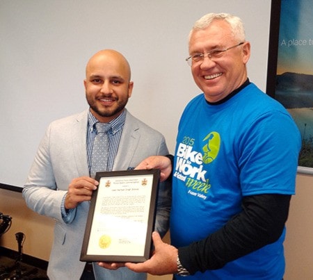 Veer Harman Singh Grewal receives a police commendation from Mayor Henry Braun.