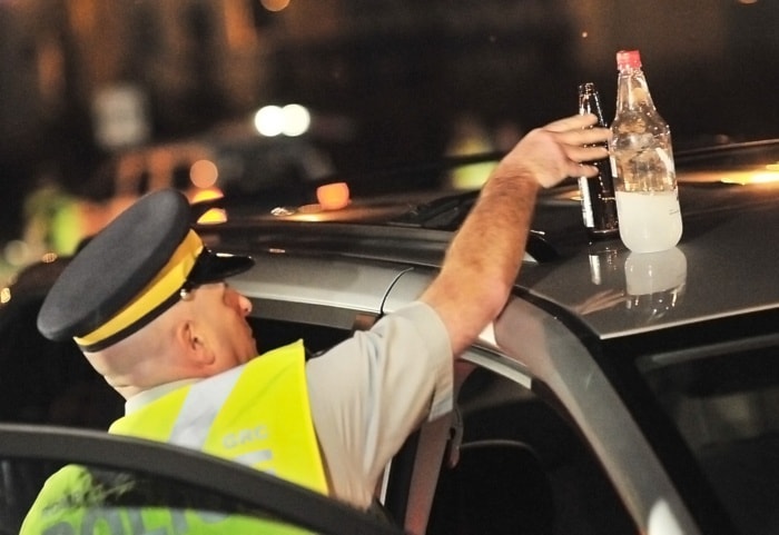 Cpl. Lorne Lecker removes open liquor from a minivan.
BOAZ JOSEPH / THE LEADER