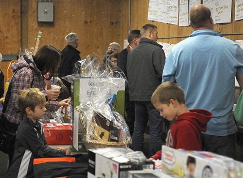 prior to auction these boys survey the toys and other items they might want.