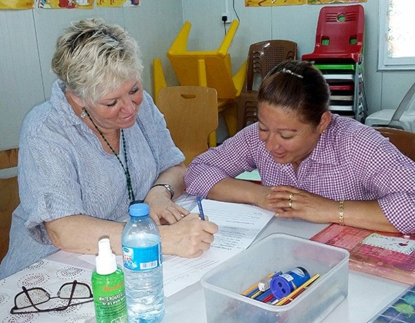 Meg Gerbrandt-Wiebe helps a student in her English class in Erbil, Iraq.