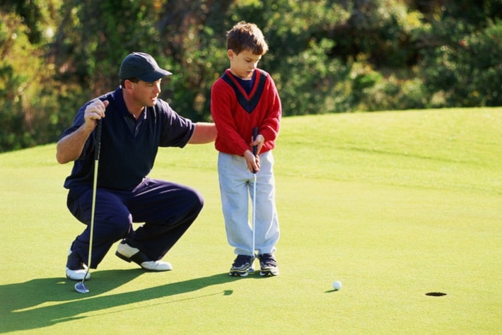 Father and son golfing