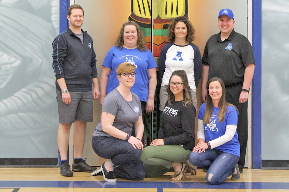 Katie Caines, Laura MacDonald, Wendy Potter, (back row) Zach Dahl, Shawna Urban, Kim Haber, and Jeremy Lyndon are ACSS students who went on to work at the school. (ACSS photo)