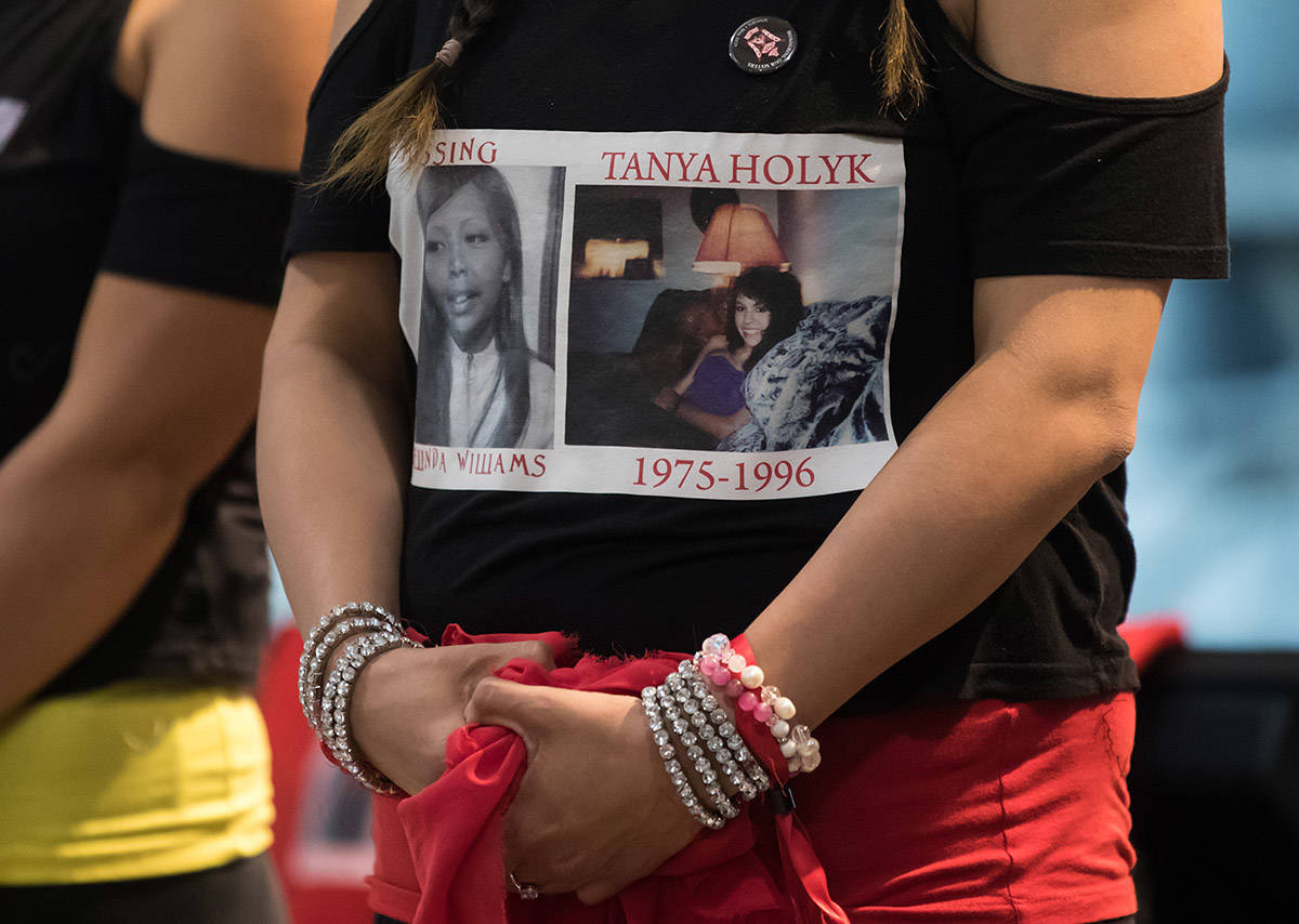 Lorelei Williams, whose cousin Tanya Holyk was murdered by serial killer Robert Pickton and aunt Belinda Williams went missing in 1978, wears a t-shirt bearing their photographs as she and her dance troupe Butterflies in Spirit wait to perform after responding to the report on the National Inquiry into Missing and Murdered Indigenous Women and Girls, in Vancouver, on Monday June 3, 2019. THE CANADIAN PRESS/Darryl Dyck