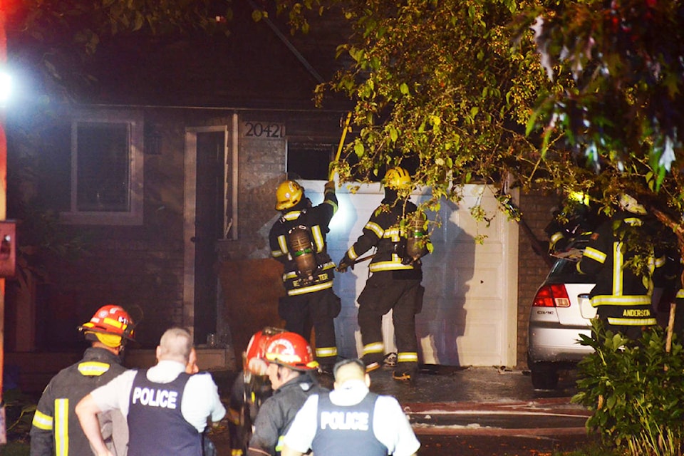 Township of Langley firefighters battle a blaze in the Walnut Grove neighbourhood on Thursday night. (Curtis Kreklau/ South Fraser News Services)