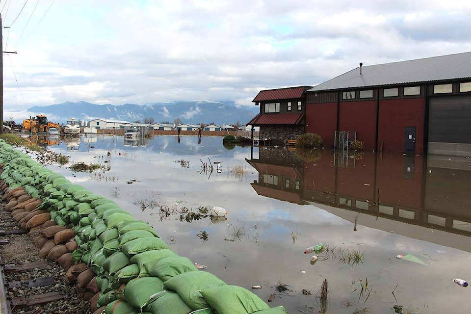 Sandbags in Huntingdon Village keep floodwaters from topping the railway tracks in the area of Second Avenue and Boundary Road on Monday, Nov. 29, 2021. (Vikki Hopes/Abbotsford News)