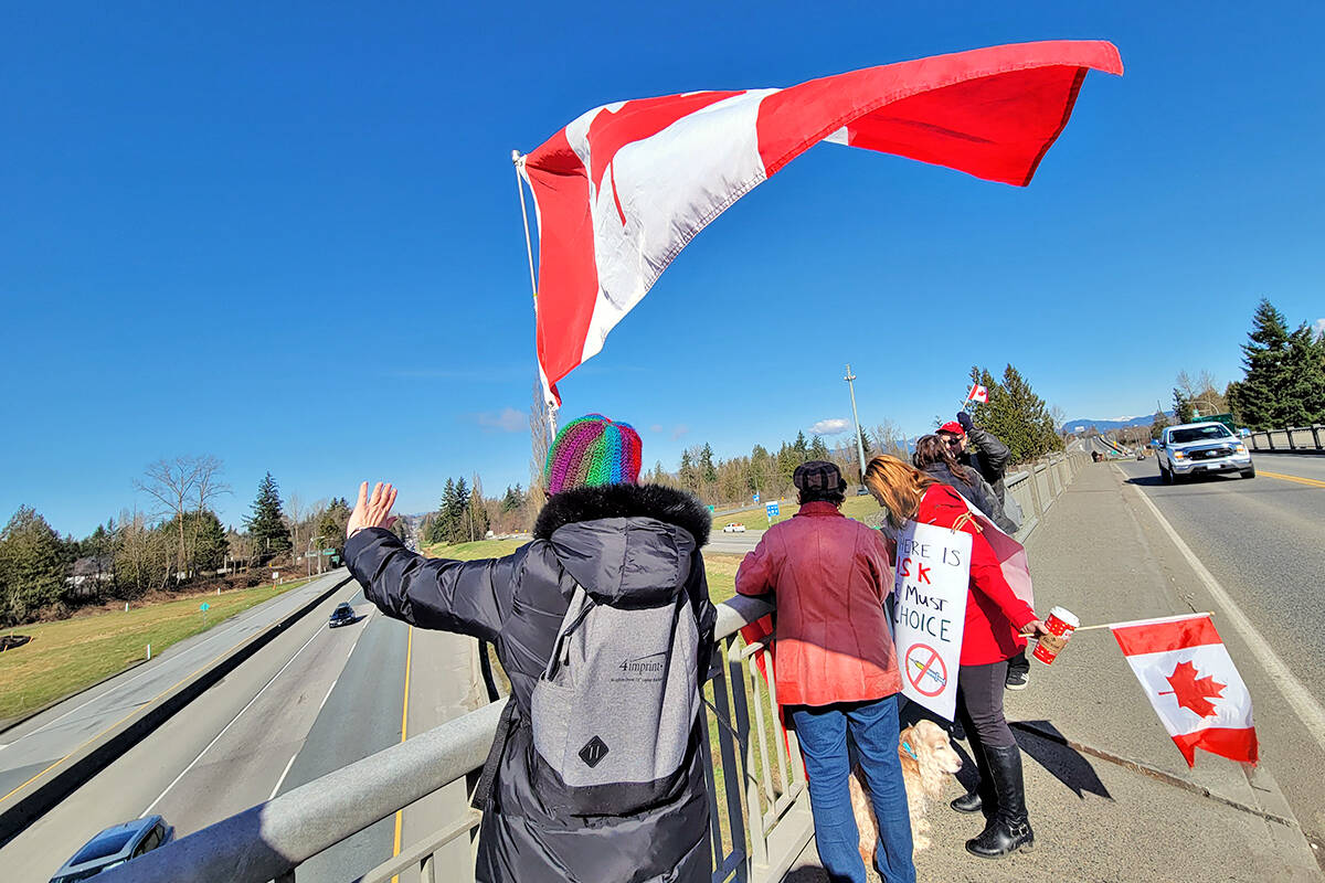 About two dozen people took park in a freedom chain anti-vaccine-mandate protest at the 232nd Street overpass on Hwy. 1 in Langley that was being held at other locations across the country. (Dan Ferguson/Langley Advance Times)