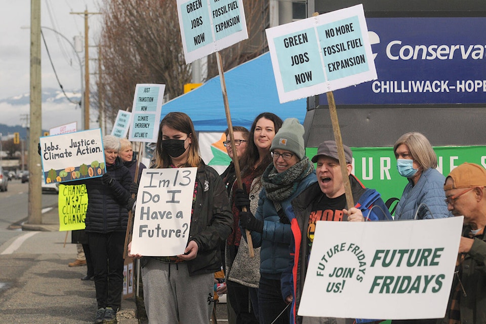 People in Chilliwack take part in the Just Transition Climate Rally outside MP Mark Strahl’s office on Saturday, March 12, 2022. (Jenna Hauck/ Chilliwack Progress)