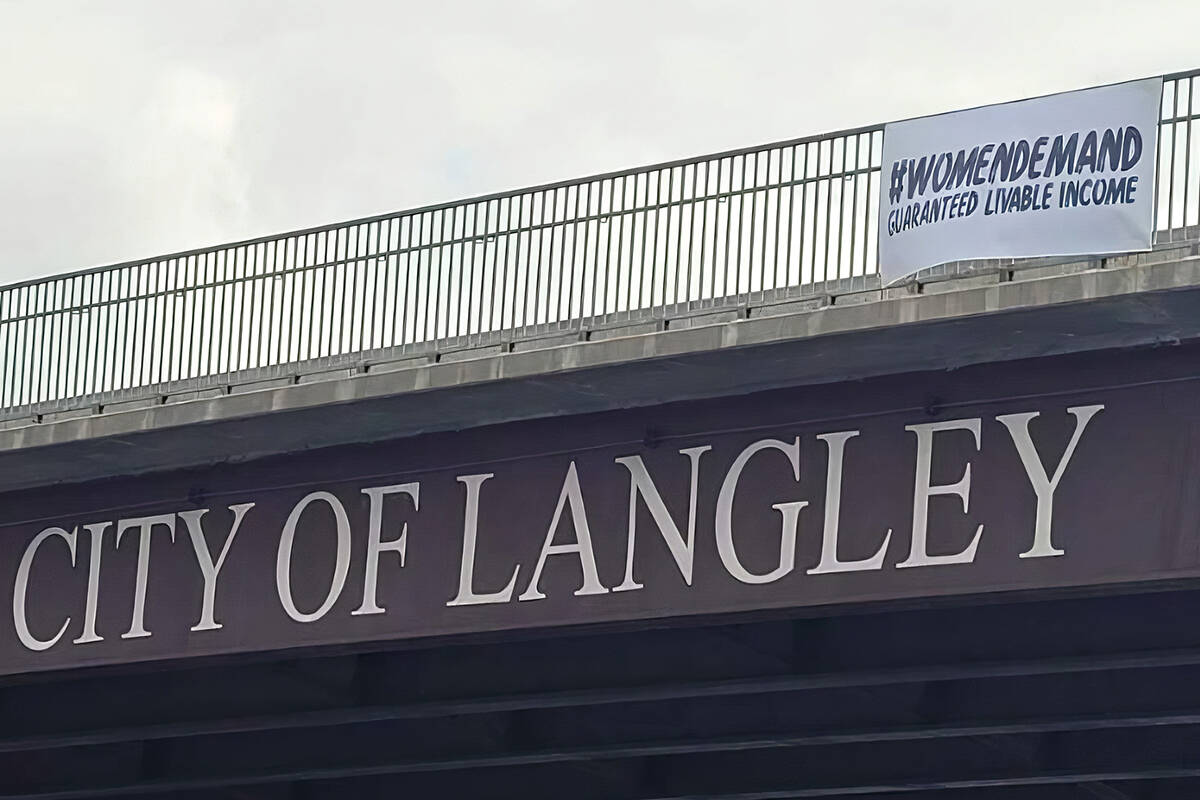 A banner calling for a guaranteed livable income went up on the 196th Street overpass in Langley on Sunday, May 1, as part of a province-wide campaign. (Special to Langley Advance Times)